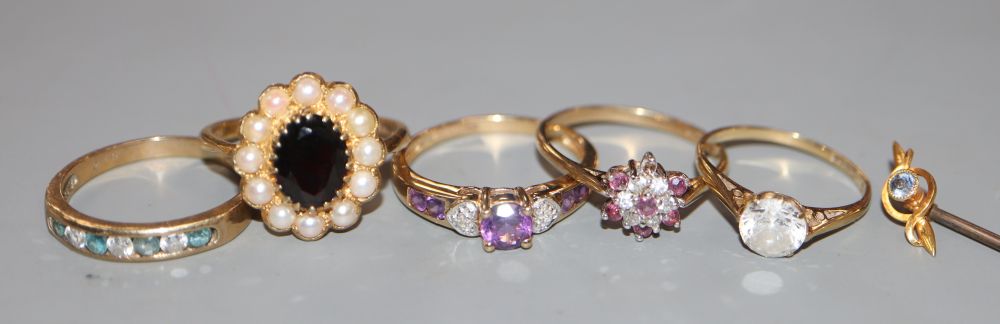 Five assorted modern 9ct gold and gem set dress rings, gross 10.9 grams and a 15ct gem set stick pin, gross 1.2 grams.